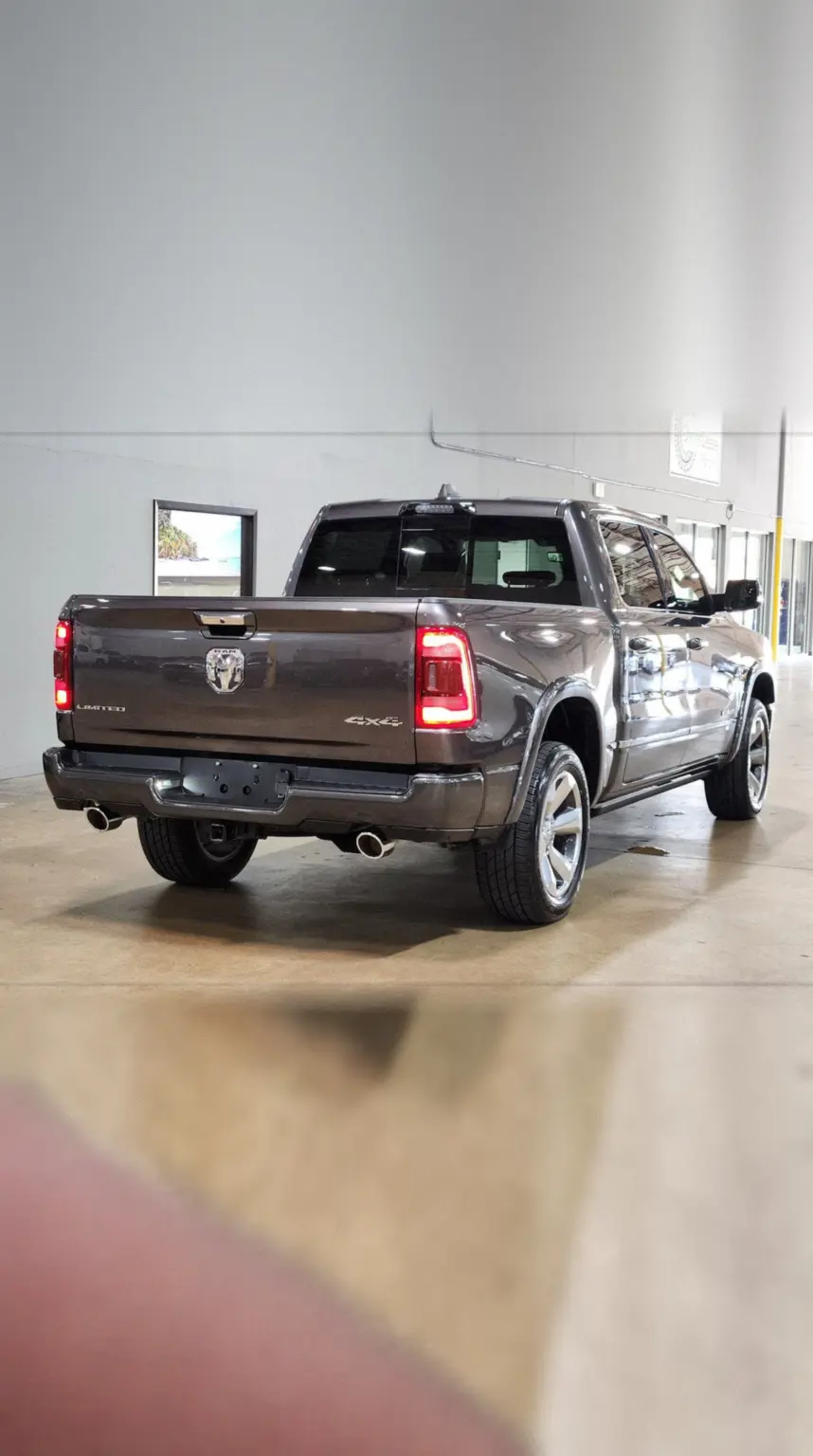 Phone camera view of a grey RAM 1500 from the rear corner